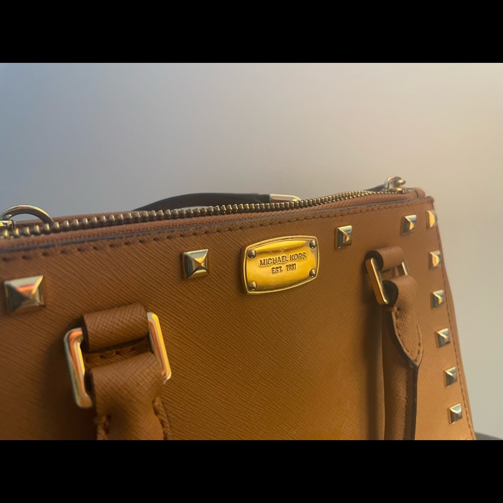 Michael Kors brown bag with gold bedazzles. Hand bag or shoulder with the strap.